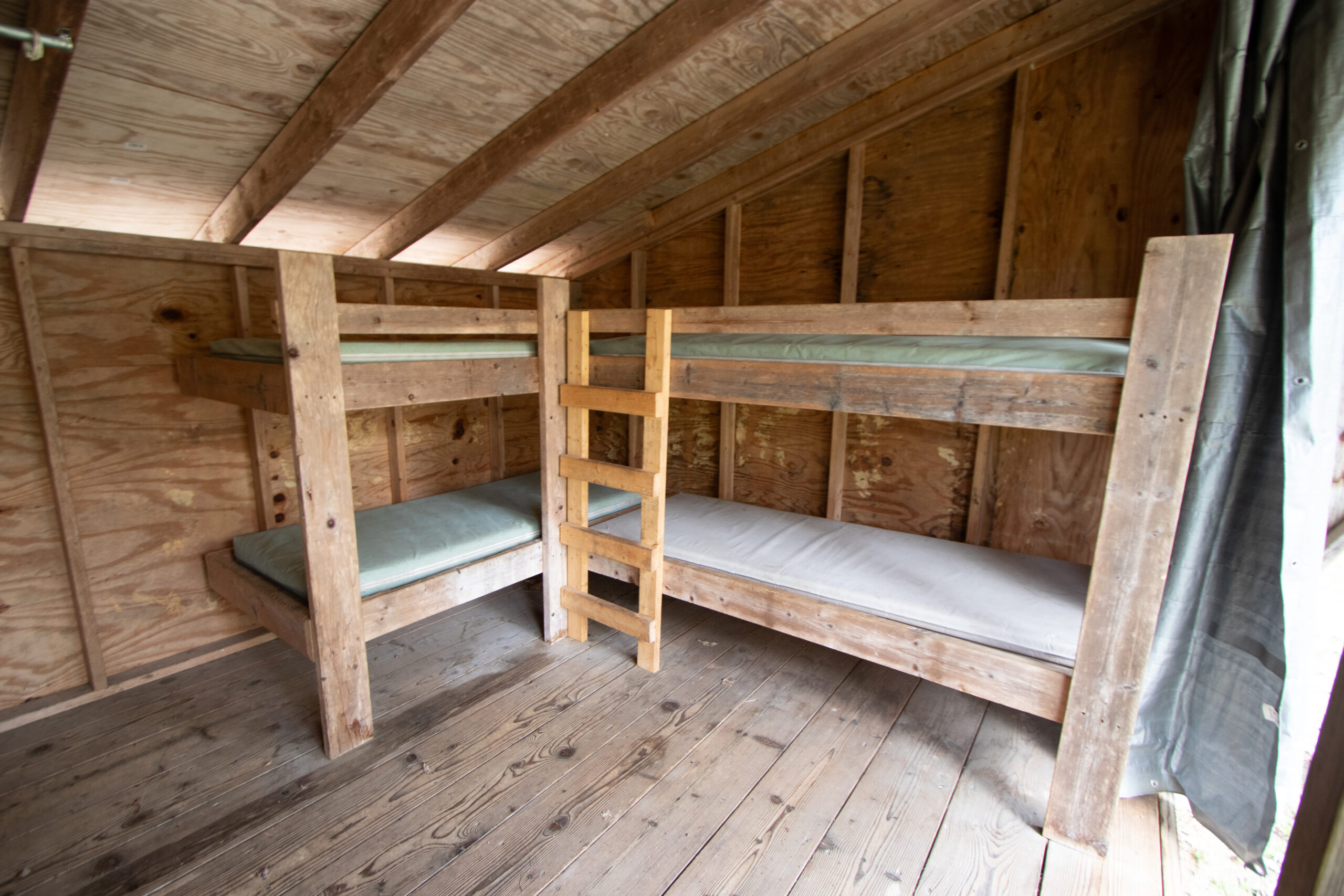 We have 17 of Lean-Tos scattered throughout our site, with 6 beds available each on a first-come, first-serve basis. Lean-Tos are popular for group encampments but also make excellent sleeping spaces during warmer months. Lean-Tos do not come with electricity or heating.